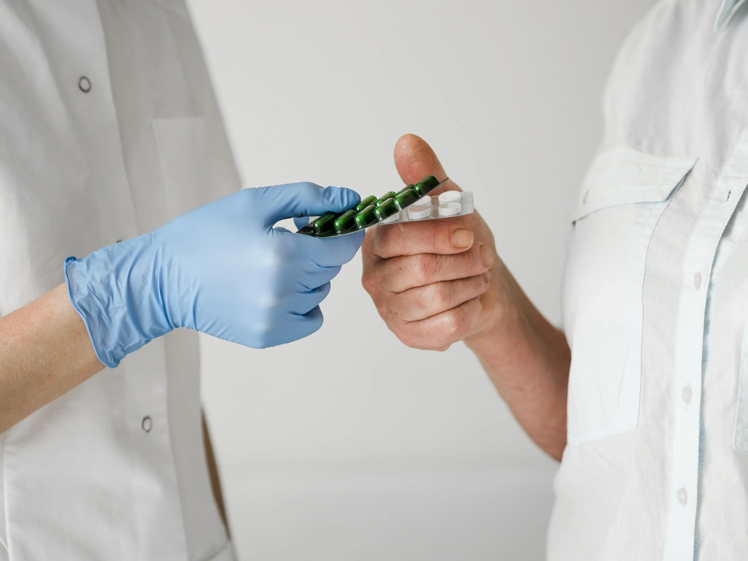 close up doctor giving pills min scaled 2